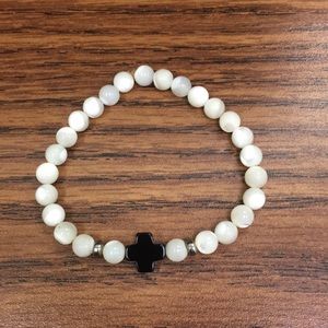 White bracelet with black cross